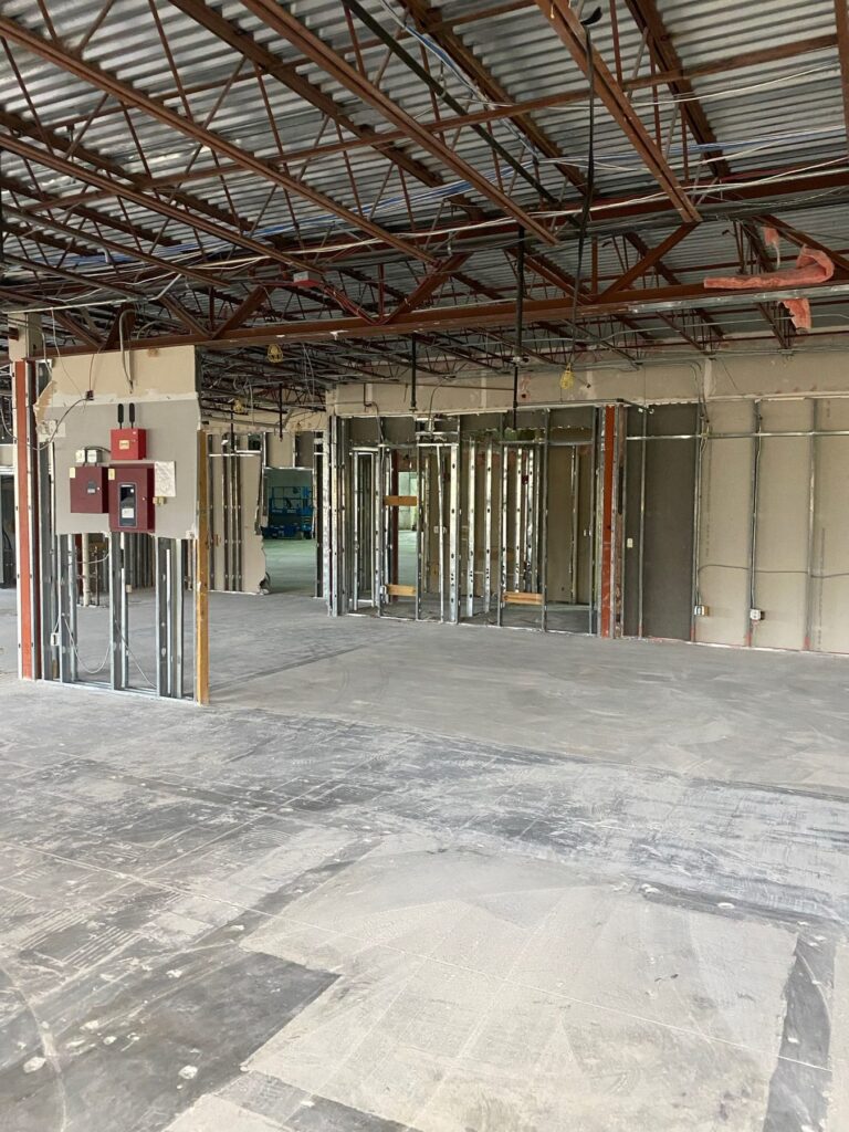 Commercial interior stripped back to steel studs and open ceiling deck during an interior demolition.