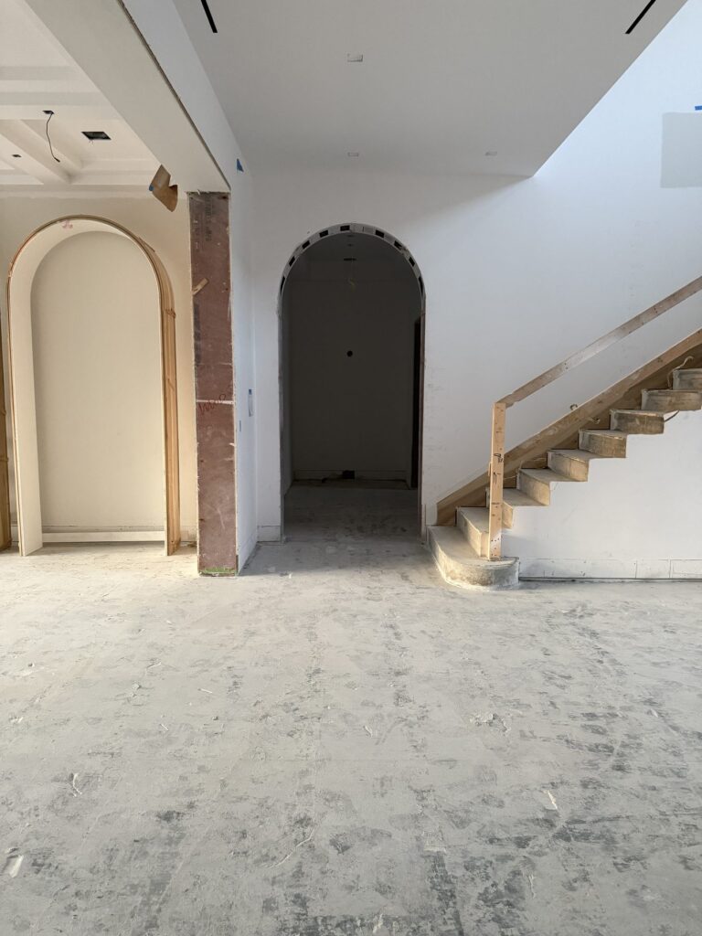 Completed gut out with the arched openings and staircase preserved, leaving the home renovation ready for the next trade.